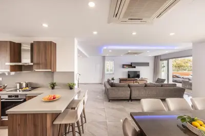 a kitchen and living room with a couch and a table at Fig Tree Bay Residences 5 in Protaras