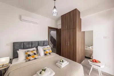 a bedroom with a large bed with two towels at Fig Tree Bay Residences 5 in Protaras