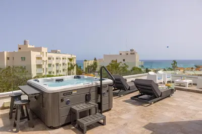 a hot tub on the roof of a building at Fig Tree Bay Residences 5 in Protaras