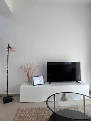 a white entertainment center with a flat screen tv at Seana Villa Protaras in Paralimni
