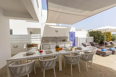 a kitchen and dining room with a table and chairs at Fig Tree Bay Residences 4 in Protaras
