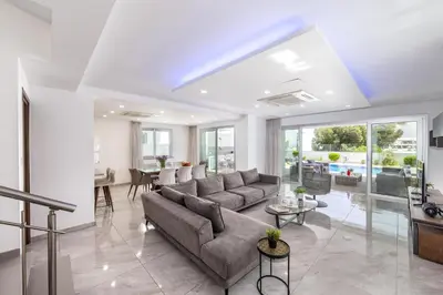 a living room with a couch and a table at Fig Tree Bay Residences 4 in Protaras