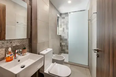 a bathroom with a white toilet and a sink at Fig Tree Bay Residences 4 in Protaras