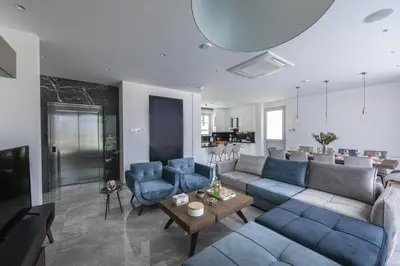 a living room with a couch and chairs and a table at Fig Tree Bay Residences 7 in Protaras