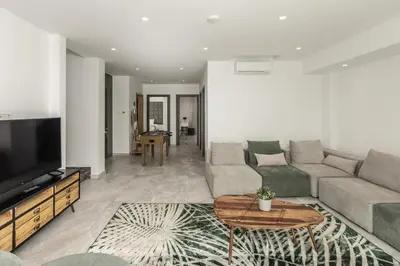 a living room with a couch and a tv at Fig Tree Bay Residences 7 in Protaras