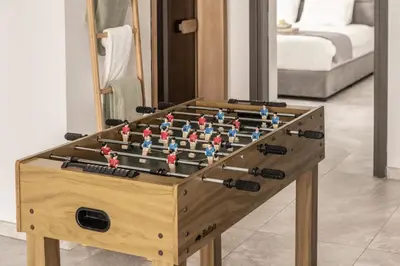 a wooden foosball table sitting in a room at Fig Tree Bay Residences 7 in Protaras