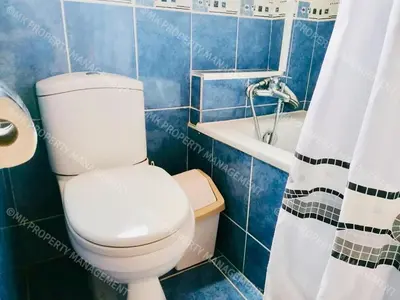 a bathroom with a white toilet and a bath tub at Merika Complex 1 Hou.32 in Larnaka