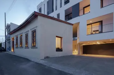 a white building with a lot of windows on a street at Alinea Suites Limassol Center in Limassol