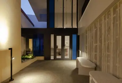 a room with a hallway with a window and a chair at Alinea Suites Limassol Center in Limassol