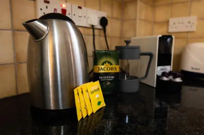 a metal thermos sitting on a kitchen counter next to a counter top at Nissi Elena -Sunshine Apt in Ayia Napa