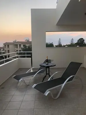 a patio with a table and chairs on a balcony at Nissi Elena -Sunshine Apt in Ayia Napa