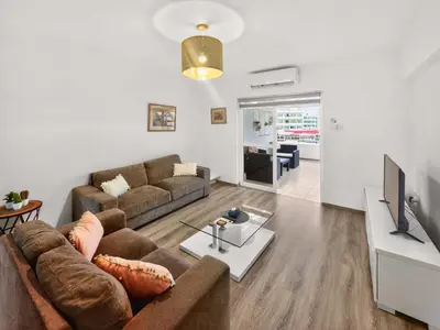 a living room with a couch and a tv at Sofia's Seaview in Protaras