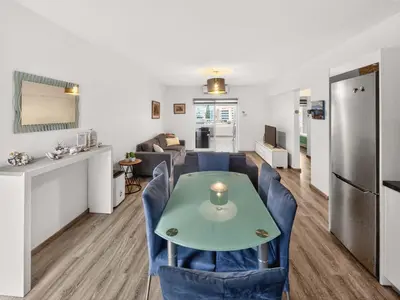 a kitchen and a living room with a table and chairs at Sofia's Seaview in Protaras