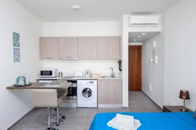 a kitchen with a washer and dryer in it at The Habitat Mediterraneo - Self Check-in in Larnaka