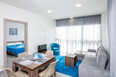 a living room with a couch and a table at The Habitat Mediterraneo - Self Check-in in Larnaka