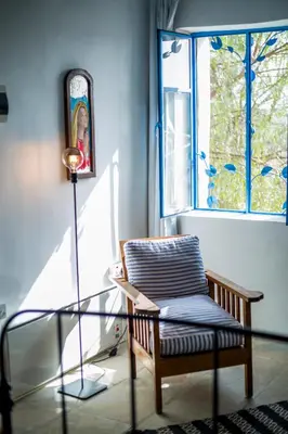 a room with a glass table and a chair and a window at Cecilias Courtyard in Malia