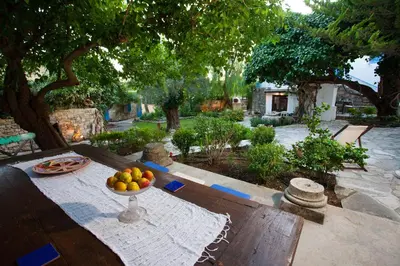 a bowl of fruit on a table in a garden at Cecilias Courtyard in Malia