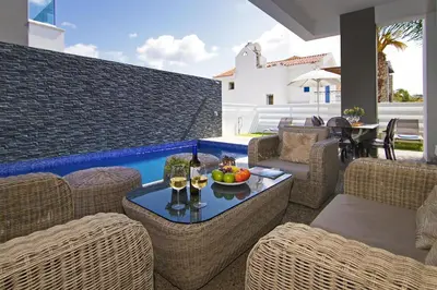 a patio with a table with glasses of wine at Villa Mey in Protaras