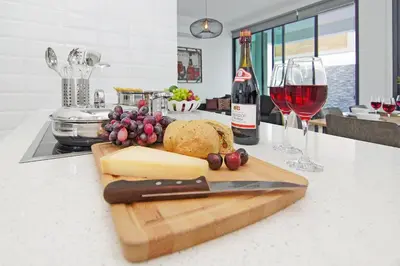 a cutting board with a knife and some wine glasses at Villa Mey in Protaras