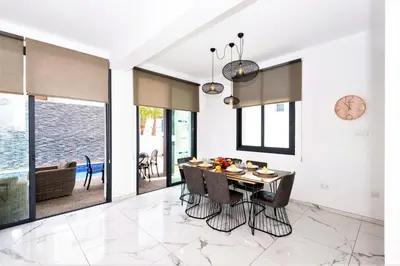 a kitchen and dining room with a table and chairs at Villa Mirella in Protaras