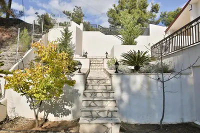 a staircase leading up to a white house at Nestor Hillside House by TrulyCyprus in Moniatis