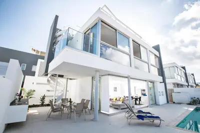 a house with a large balcony with a pool at Blue Pearl Villas in Protaras