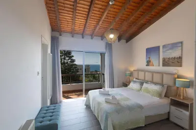 a bedroom with a large bed and a balcony at Rosie Villa in Ayia Napa