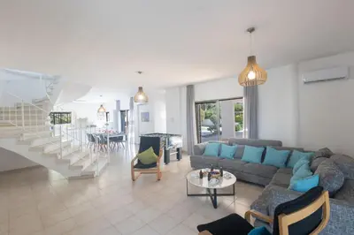 a living room with a couch and a table at Rosie Villa in Ayia Napa