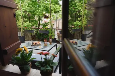 a balcony with two tables with food and flowers at Serenity Boutique House in Vouni