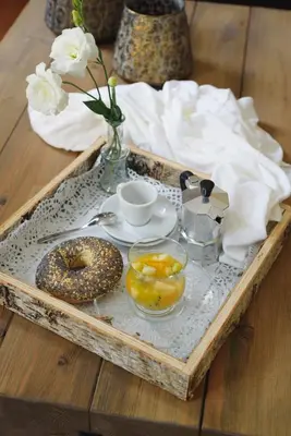 a tray with donuts and a vase of flowers on a table at Serenity Boutique House in Vouni