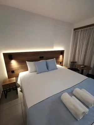 a bedroom with a large white bed with two pillows at Shalos Studios in Ayia Napa