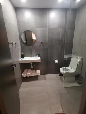 a bathroom with a shower with a toilet and a sink at Shalos Studios in Ayia Napa
