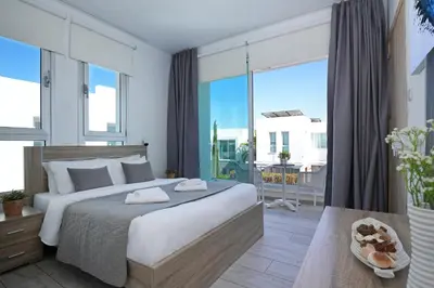 a bedroom with a large bed and a large window at Villa Carmen in Protaras