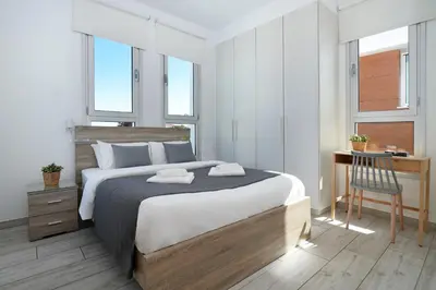 a bedroom with a bed and a desk with a chair at Villa Carmen in Protaras