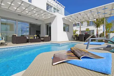 a house with a swimming pool and a house at Villa Sunday in Ayia Napa