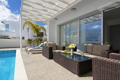 a living room with a pool and a villa at Villa Sunday in Ayia Napa