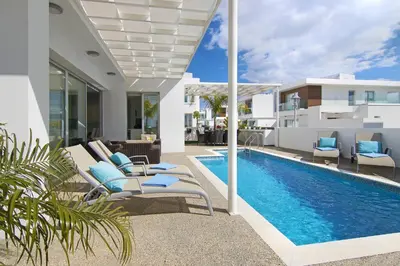 a villa with a swimming pool and a house at Villa Sunday in Ayia Napa