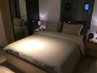 a bedroom with a large bed and a mirror at Kennedy Deluxe Suites in Nicosia