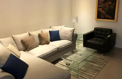 a living room with a couch and a chair at Kennedy Deluxe Suites in Nicosia
