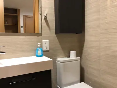 a bathroom with a toilet and a sink and a mirror at Kennedy Deluxe Suites in Nicosia