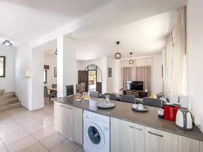 a kitchen and living room with a washing machine at Villa Socrates in Protaras