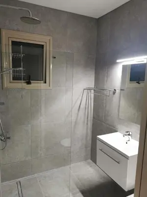 a bathroom with a shower and a sink and a toilet at Sea view apartment in Protaras