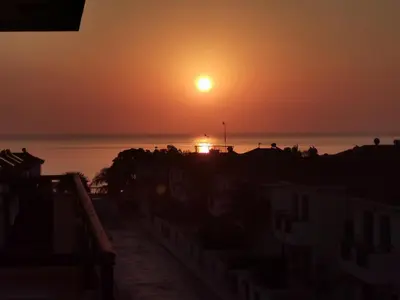 a sunset over the ocean with the sun in the sky at Sea view apartment in Protaras