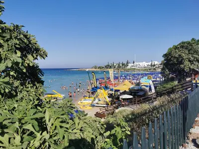 a beach with a bunch of people in the water at Sea view apartment in Protaras