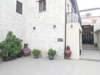a building with potted plants on the side of it at Omodos Maria's Apartments in Omodos