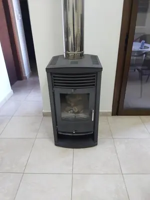 a black stove sitting on a tile floor with a blender at Omodos Maria's Apartments in Omodos