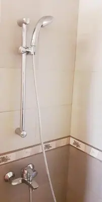 a shower in a bathroom with a sink at Omodos Maria's Apartments in Omodos
