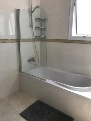 a bathroom with a shower and a bath tub at Villa Julia in Ayia Napa