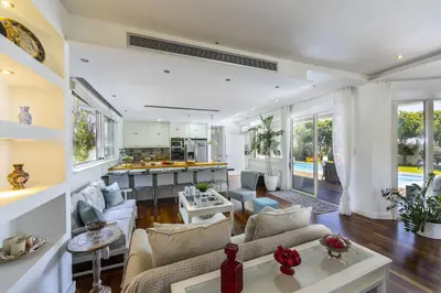 a living room with couches and a kitchen at Larnaca Villa Marisol Kiti in Larnaka