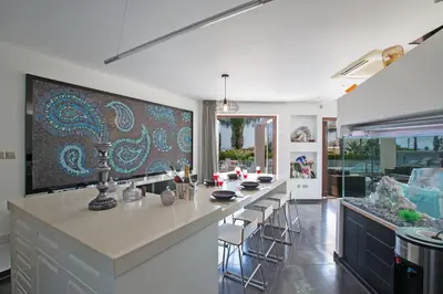 a kitchen with a large island with bar stools at Oscar Domain Villa in Protaras